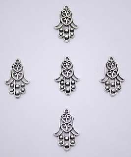 These pendants are hamsa amulets, ancient symbols picturing an opened 