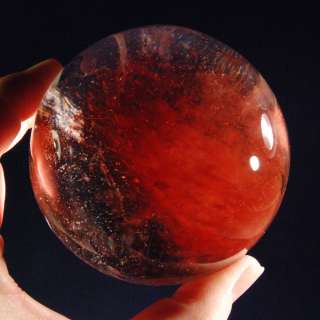 You are considering a beautiful cherry quartz sphere with a hematite 