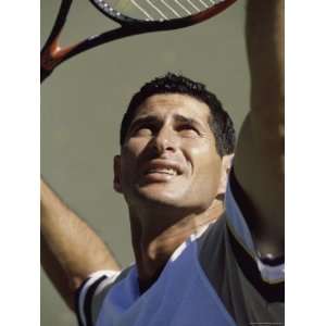  Man Preparing to Hit Tennis Ball with Racquet Photographic 