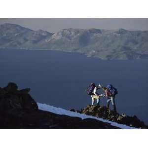  Hikers Pause to Look at Maps Above Lake Tahoe on Mount 