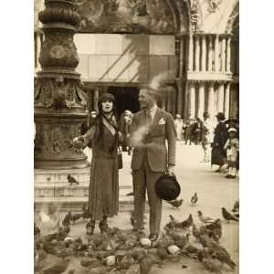  A Couple Surrounded by Pigeons in St Marks Square, Venice 